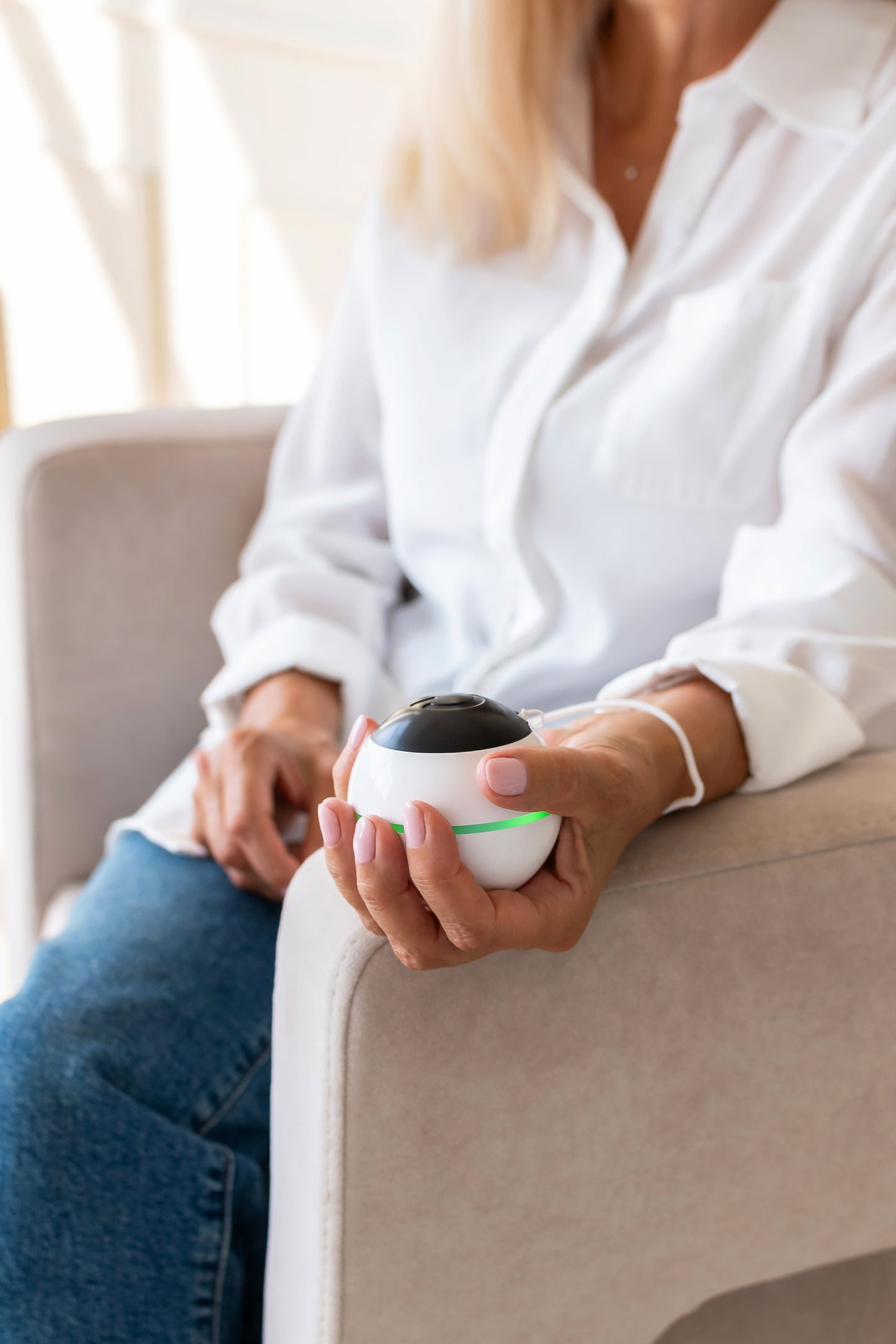 Habeo handheld device for essential tremor relief, being used by a younger patient. 